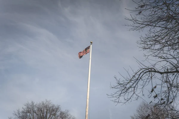 American flag waving in the wind, at the American cemetery at Magraten in The Netherlands.