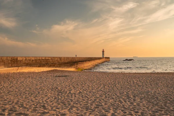 stock image Farolim de Felgueiras, Pier and lighthouse at Porto, Portugal During sunset.