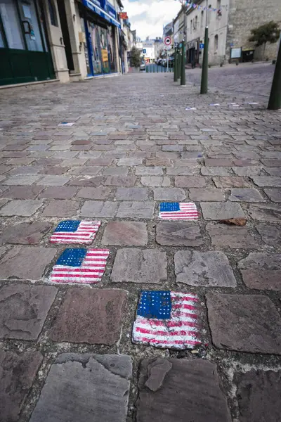 Cable stones painted with the American flag in Carentan France.