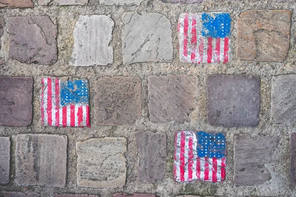 Cable stones painted with the American flag in Carentan France.