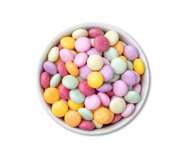 Colorful candies in a bowl isolated over white background.