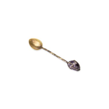 Old decorated metal tea spoon isolated over white background.