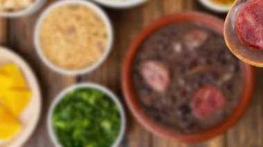 Odaklanmamış arka planda kaşık içinde geleneksel Brezilyalı feijoada.