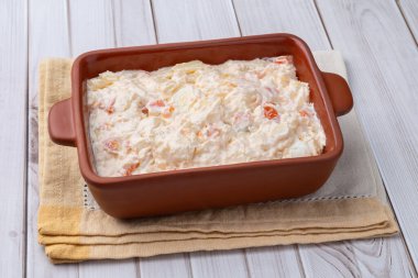 Rus salatası ya da mayonez salatası ahşap bir masanın üzerinde..