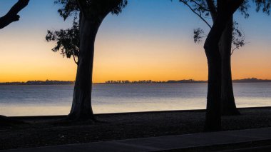 Landscape view of a beautiful sunset over Chascomus lake, Buenos Aires                                       clipart