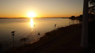 Landscape view of a beautiful sunset over Chascomus lake, Buenos Aires                                       clipart