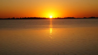 Landscape view of a beautiful sunset over Chascomus lake, Buenos Aires                             clipart