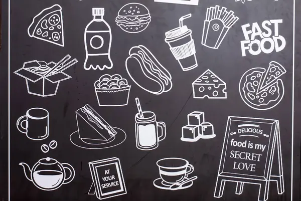 stock image Hand drawn fast food symbol on chalkboard in front of restaurant.