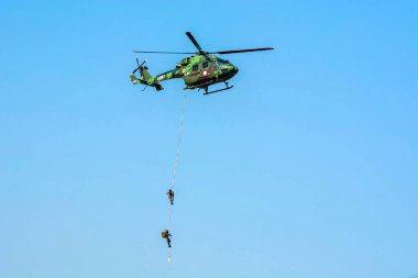 Kolkata, Hindistan 15 Aralık 2022. Para komando helikopterden kayıyor ve halatla kayıyor. Hint Hava Kuvvetleri, yeteneklerini halkın önünde gösteriyor..