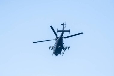İzole edilmiş mavi gökyüzünde uçan bir helikopter.