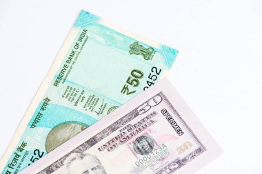 US dollar and Indian currency exchange rate. Close-up of US dollar and Indian paper currency. clipart