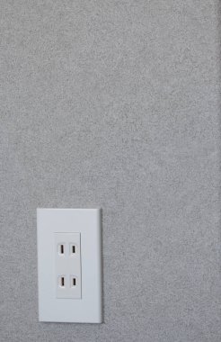 Japanese two pin electric plug socket on grey wall background