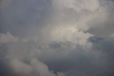 Dark and light sunlit thunderstorm clouds in the sky