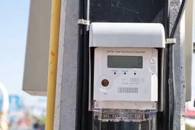 Digital electricity meter on pole. Closeup smart meter controlled and communicated via RF radio to mobile phones and Wi-Fi devices in real time with selective focus.