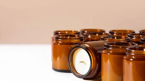 Group of Handmade Soy and coconut wax candles in a Amber and opaque container, brown glass jar. Natural eco friendly organic candles. Concept sustainability and vegan plastic free product. Copy space