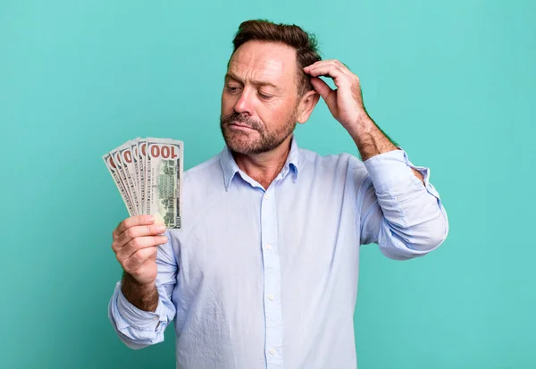 Middle Age Man Feeling Puzzled Confused Scratching Head Dollar Banknotes — Stockfoto