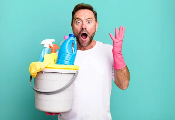 Middle Age Man Feeling Extremely Shocked Surprised Housekeeper Clean Products — Stock Photo, Image