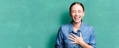 caucasian pretty woman laughing out loud at some hilarious joke