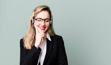 smiling with a happy, confident expression with hand on chin. telemarketer concept