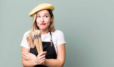 shrugging, feeling confused and uncertain. artist painter concept