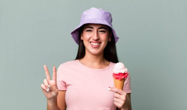 smiling and looking friendly, showing number two. ice cream and summer concept
