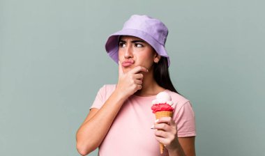 thinking, feeling doubtful and confused. ice cream and summer concept