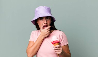 with mouth and eyes wide open and hand on chin. ice cream and summer concept