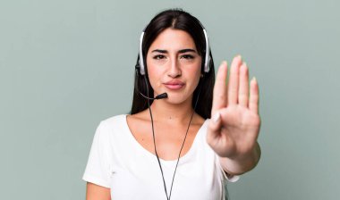 looking serious showing open palm making stop gesture. telemarketer concept