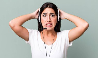 feeling stressed, anxious or scared, with hands on head. telemarketer concept