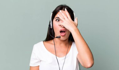 looking shocked, scared or terrified, covering face with hand. telemarketer concept