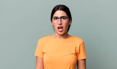 Şok olmuş ya da şaşırmış görünüyor, ağzı açık bakıyor ve 