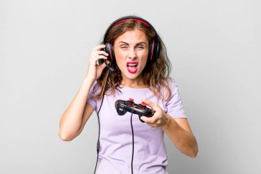 hispanic pretty young woman playing with headphones and a control. gamer concept