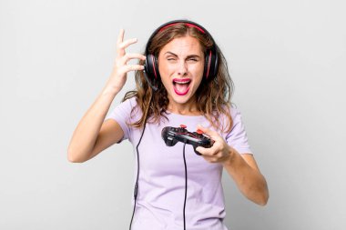 hispanic pretty young woman playing with headphones and a control. gamer concept