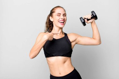 hispanic pretty young woman lifting a dumbbell. fitness concept