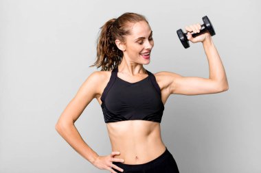 hispanic pretty young woman lifting a dumbbell. fitness concept