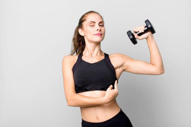 hispanic pretty young woman lifting a dumbbell. fitness concept