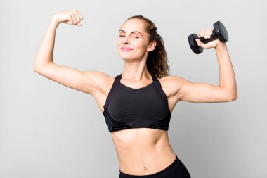 hispanic pretty young woman lifting a dumbbell. fitness concept