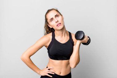 hispanic pretty young woman lifting a dumbbell. fitness concept