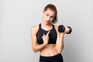 hispanic pretty young woman lifting a dumbbell. fitness concept