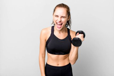 hispanic pretty young woman lifting a dumbbell. fitness concept
