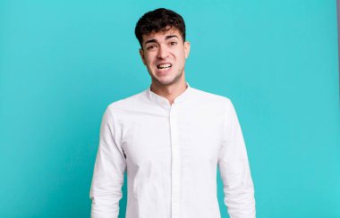 man feeling puzzled and confused, with a dumb, stunned expression looking at something unexpected