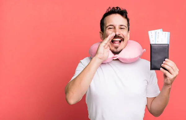 adult man feeling happy,giving a big shout out with hands next to mouth. flight passenger concept