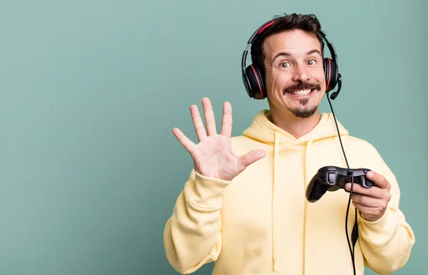 Adult Man Smiling Looking Friendly Showing Number Five Headset Control — Stockfoto