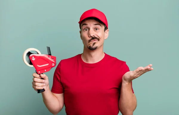 Adult Man Feeling Puzzled Confused Doubting Deliveryman Packer Concept — Stockfoto