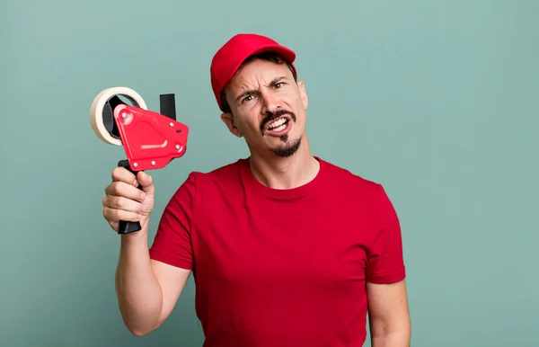Adult Man Feeling Puzzled Confused Deliveryman Packer Concept — Stockfoto