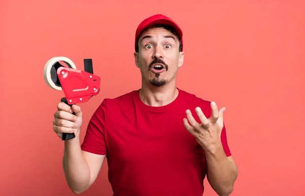 Adult Man Feeling Extremely Shocked Surprised Deliveryman Packer Concept — Stockfoto
