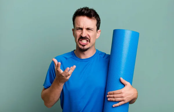 adult man looking angry, annoyed and frustrated. fitness and yoga concept