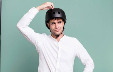 Yetişkin adam şaşkın ve kafası karışık, kaşınan bir kafa hissediyor. şehir motosiklet sürücüsü konsepti