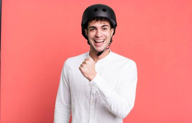 Yetişkin bir adam kendini mutlu hisseder ve bir meydan okumayla yüzleşir ya da kutlama yapar. şehir motosiklet sürücüsü konsepti