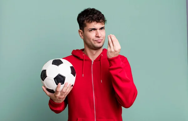adult man making capice or money gesture, telling you to pay. soccer and sport concept